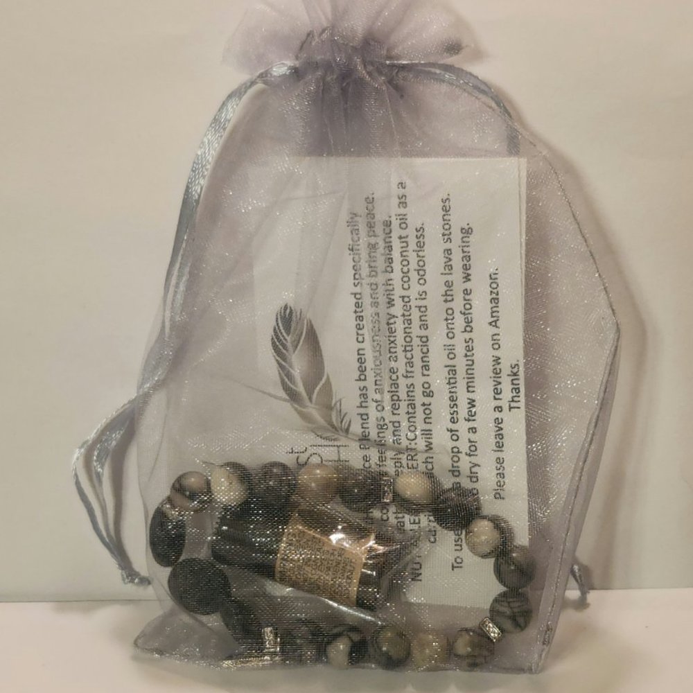 Aroma therapy Lava Stone Diffuser bracelet with Essential Oil sample.